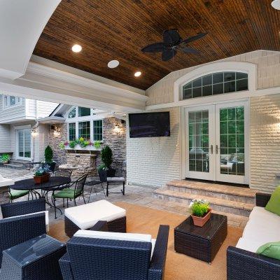 Covered Patio with barreled bead-board ceiling and cozy outdoor seating