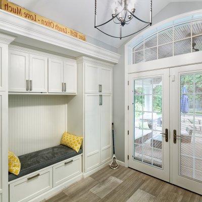 New Mud Room with built-in bench, white cabinets, french doors