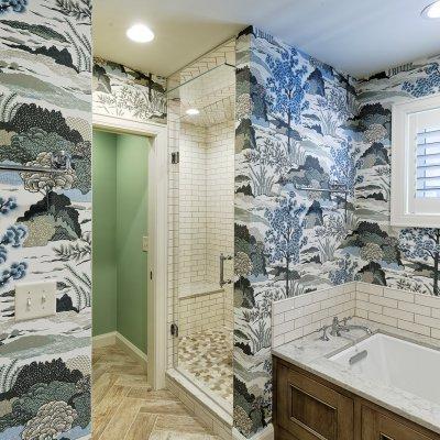 bathroom addition with decorative blue and white wallpaper  